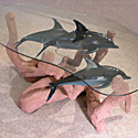 Glass-top table with 3 dolphins